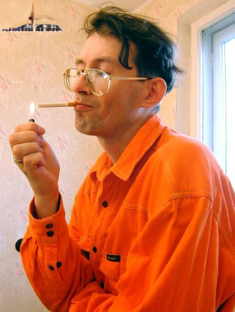 Young redhead lights up a cigar prior to having sex with an older man