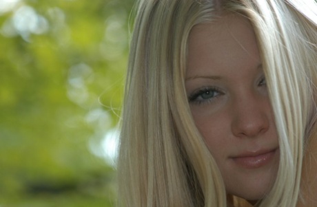 Charming blonde teen Tiffany hikes skirt over cotton panties in the forest