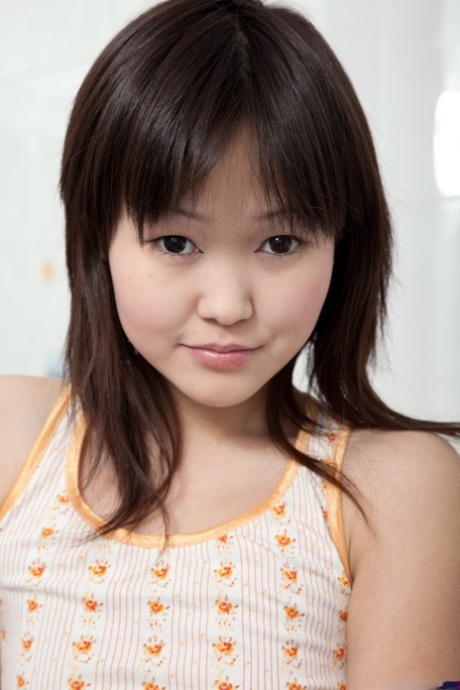 Young looking Asian girl wets and fingers her pussy while in a bathtub