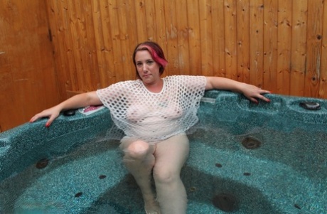 Plump amateur removes a mesh top while relaxing in an outdoor hot tub