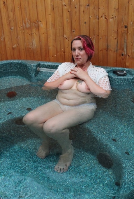 Plump amateur removes a mesh top while relaxing in an outdoor hot tub