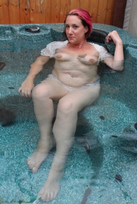 Plump amateur removes a mesh top while relaxing in an outdoor hot tub