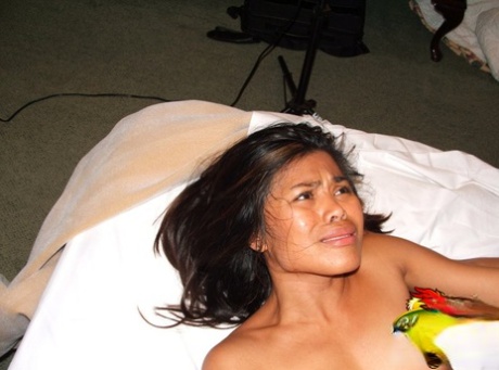 Asian teen Arcadia Davida has sexual intercourse on a bed with a black guy