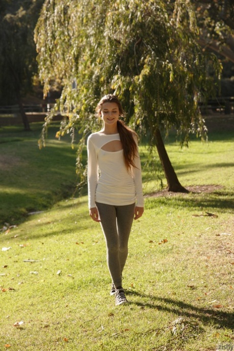 Brunette teen Alex Mae exposes her nice ass in the park on canvas sneakers